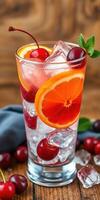 Refreshing cocktail with cherries and orange slices on a wooden table in a cozy setting photo