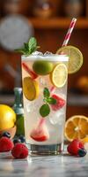 Refreshing citrus lemonade with mint and mixed berries served in a tall glass on a kitchen counter photo