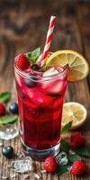 Refreshing berry lemonade drink with mint and ice on rustic wooden table photo