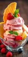 Delicious ice cream sundae with strawberries, lemon, and mint displayed in a glass bowl photo