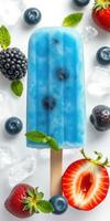 Colorful frozen pop surrounded by fresh berries and mint on a bright background photo