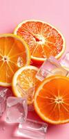 Fresh orange slices arranged with ice cubes on a pink background create a vibrant and refreshing summer vibe photo