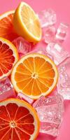 Vibrant citrus slices resting on ice cubes against a pink background in a refreshing display photo
