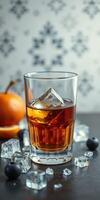 Refreshing cocktail in a glass with ice cubes garnished with fruit on a stylish tabletop photo