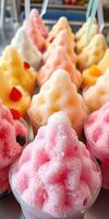Colorful fruit-flavored frozen desserts served in clear cups at a summer festival photo