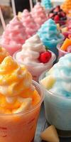Colorful frozen desserts topped with whipped cream and fruits during a summer gathering at a local event photo