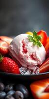 Delicious strawberry ice cream served with fresh strawberries and blueberries in a black bowl photo
