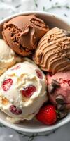 Delightful array of colorful ice cream scoops served in a bowl with fresh strawberries arranged on a decorative surface photo