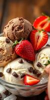 Delicious ice cream sundae topped with fresh strawberries and chocolate chips at a summer gathering photo