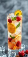 Refreshing summer drink with raspberries, lemons, and mint served over ice in a tall glass photo
