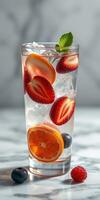 Refreshing summer drink with fresh fruits and mint on a marble countertop photo