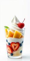 Delicious dessert featuring whipped cream, fresh fruit, and vibrant colors served in a clear cup photo