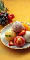 Colorful sorbet assortment with fresh fruit on a vibrant yellow background photo