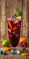 Refreshing fruit punch served in a tall glass with ice and garnished with citrus photo