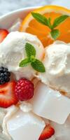 Delicious dessert bowl with ice cream, fresh fruits, and mint leaves at a sunny outdoor setting photo