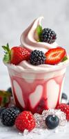 Delicious frozen yogurt topped with fresh berries and mint served in a cup at a summer dessert event photo