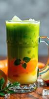 Refreshing layered drink with vibrant colors served in a clear glass on a wooden table photo