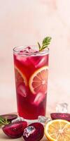 Refreshing beverage with citrus slices and ice in a tall glass on a light background photo