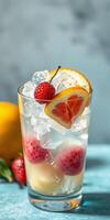 Refreshing summer drink with ice, fruits, and vibrant garnishes on a blue background photo