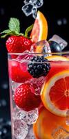 Refreshing summer fruit cocktail with ice and mint leaves on a dark background photo