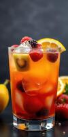 Refreshing fruit cocktail with berries and citrus garnished in a glass on a dark background photo