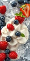 Creamy dessert topped with fresh berries and mint leaves on crushed ice for a refreshing summer treat photo