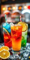 Colorful summer cocktails served in tall glasses with ice and fruit garnishes at a lively bar setting photo