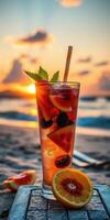 Refreshing summer cocktail garnished with fruit during sunset at the beach photo