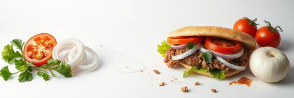 Delicious sandwich with meat, vegetables, and fresh ingredients prepared on a white background photo