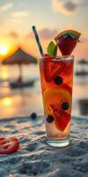 Refreshing fruit cocktail served during sunset on a serene beach with a vibrant sky photo