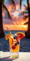 Refreshing tropical drink with fruit at sunset on a beach in a tropical paradise photo