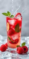 Refreshing raspberry lemonade with mint and ice cubes in a tall glass photo