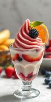 Delicious dessert with swirled strawberry and yogurt topped with fresh berries and citrus photo