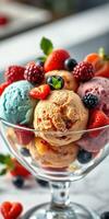 Colorful bowl of assorted ice cream topped with fresh strawberries, blueberries, and blackberries in a dessert glass photo