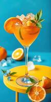 Refreshing citrus cocktail served in a stylish glass on a vibrant yellow table with fresh oranges and ice photo