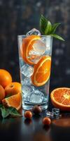 Refreshing orange drink with ice and citrus slices in a glass surrounded by fresh oranges photo