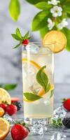 Refreshing summer drink with mint and citrus on a marble countertop surrounded by fruits photo