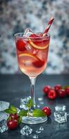 Refreshing summer cocktail garnished with cherries and mint on a dark surface photo