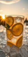 Refreshing lemon beverage served over ice with sunset glow in the background photo