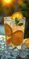 Refreshing citrus drink with ice and mint leaves on a warm sunset evening photo
