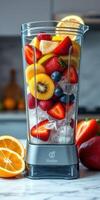 Fruit blender filled with fresh strawberries, oranges, bananas, and blueberries ready to make a smoothie photo