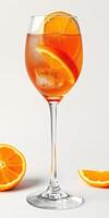 Refreshing orange cocktail served in a tall glass with citrus slices on a clean background photo