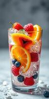 Refreshing fruit drink filled with colorful berries and citrus on a bright background photo