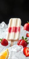 Strawberry and lemon ice cream popsicle placed on ice with fresh strawberries and lemon slices photo