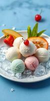 Colorful assortment of ice cream scoops served on a plate with fresh fruits and ice cubes photo
