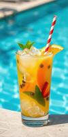 Refreshing tropical cocktail served beside a sparkling pool on a sunny day photo