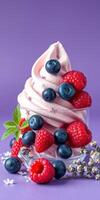 Delicious soft serve ice cream topped with fresh raspberries and blueberries against a vibrant purple background photo