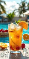 Refreshing tropical drink by the poolside with fresh fruits and ice on a sunny day photo