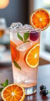 Refreshing citrus beverage garnished with orange slices and mint leaves on a bright surface photo