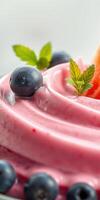 Delicious creamy dessert topped with blueberries and mint leaves on a bright background photo